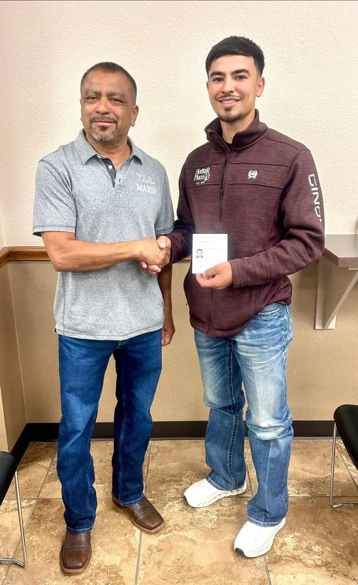 A TIA instructor congratulates a CDL graduate
