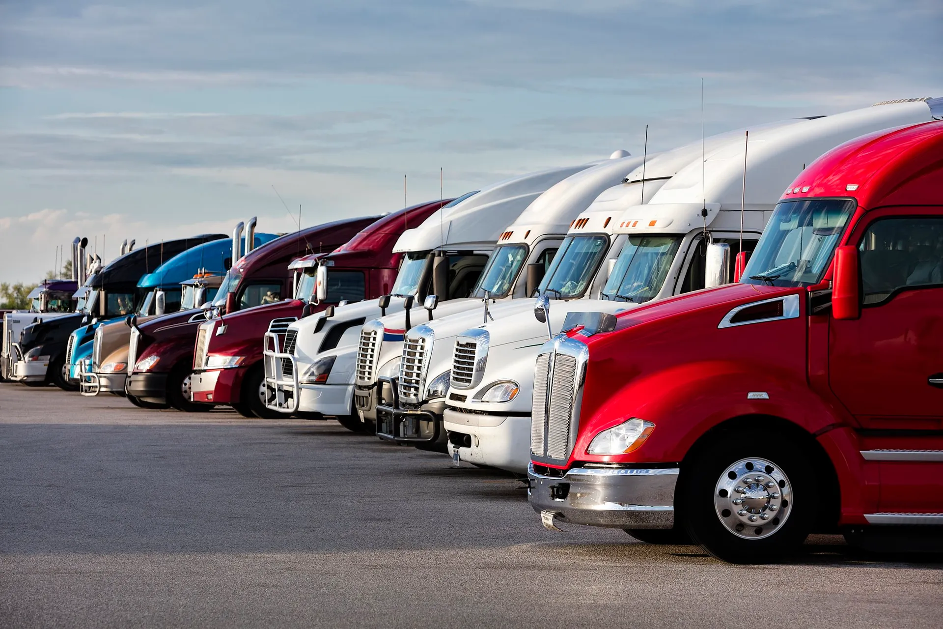 A row of commercial trucks ready for training